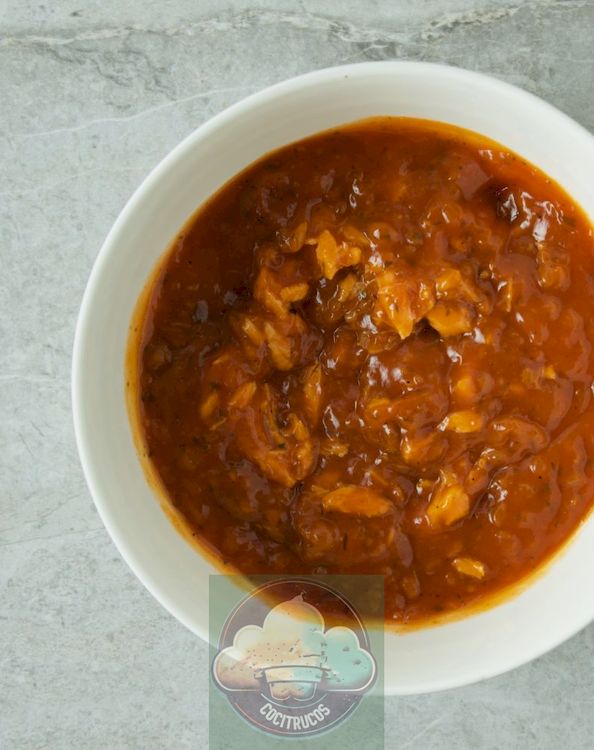 trozos de salmón en escamas recalentados en salsa de tomate caliente